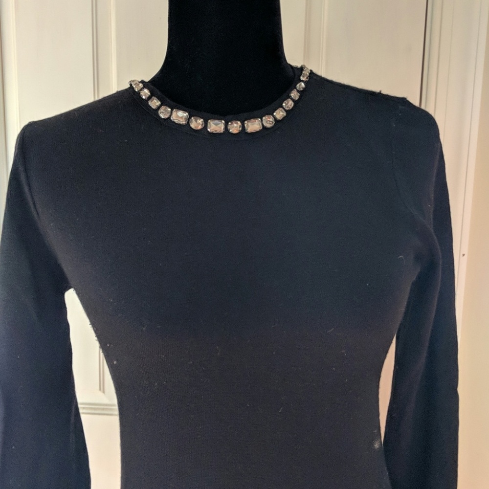 Black sweatsr with jeweled detailing on collar
